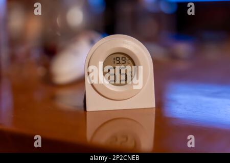 Electronic thermometer hygrometer measuring the optimal temperature and humidity in a room Stock Photo