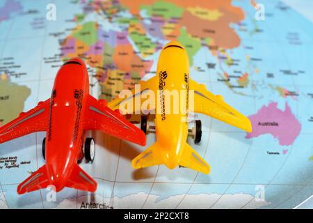 Colorful world map with airplane on it with the continents Africa, Europe, North America, Asia, South America, Australia and Antarctica, Travel, trans Stock Photo