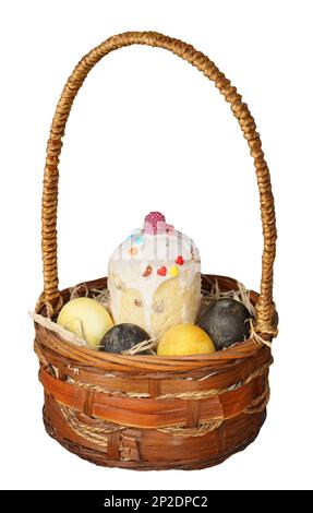 Basket with Easter cake and painted eggs on isolated white background Stock Photo