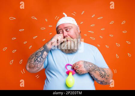 Funny man with wig act like a baby and cries for something Stock Photo