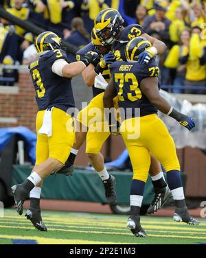 Chris Wormley of the Michigan Wolverines sacks quarterback Trace