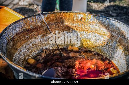 Cooking in a large pot, outside Stock Photo - Alamy