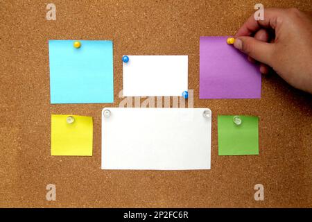 Multicolored notes for messages and reminders on cork board Stock Photo