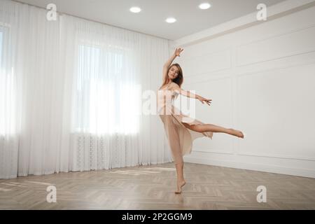Beautiful professional dancer practicing moves in studio Stock Photo