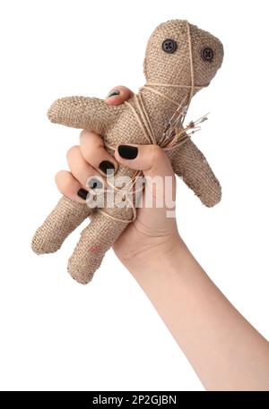 Woman holding voodoo doll with pins on white background, closeup Stock Photo