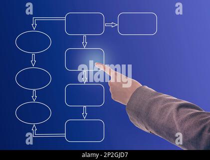 Woman pointing at flowchart on virtual screen against blue background, closeup. Business process Stock Photo