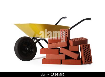 Many red bricks with wheelbarrow on white background Stock Photo