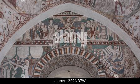jesus christ on judgment day, sitting on a rainbow, an 500 years old mural in Keldby Church, Denmark, October 10, 2022 Stock Photo