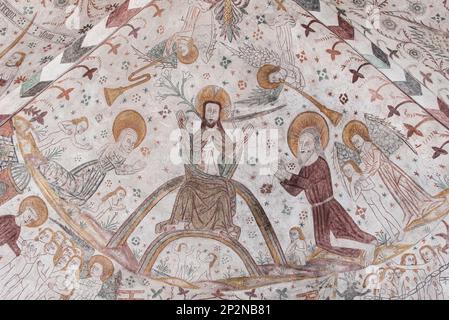on the judgment day Christ stits on the rainbow, an 500 years old mural in Keldby Church, Denmark, October 10, 2022 Stock Photo