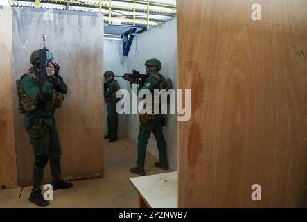 Ivorian Special Forces soldiers execute tactical movements out of a ...