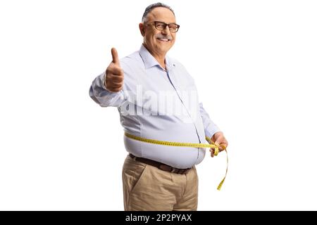 Cheerful mature man measuring waist with a tape and gesturing thumbs up isolated on white background Stock Photo