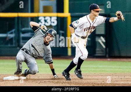 June 24, 2015: After fielding a ground ball, Vanderbilt shortstop Dansby  Swanson #7 underhands the ball to teammate 2nd baseman Tyler Campbell #2 to  turn the double-play in action during game 3