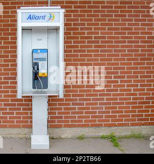 Saint John, NB, Canada - August 13, 2014: An open phone booth with a push button phone. The phone is operational as can be seen by its LED display. Br Stock Photo