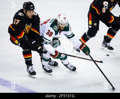 Edmonton Oilers defenceman Brett Kulak, right, is checked by Calgary Flames  forward Milan Lucic during first period NHL second-round playoff hockey  action in Calgary, Thursday, May 26, 2022. THE CANADIAN PRESS/Jeff McIntosh