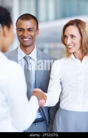 Deal cracked. Portrait of handshake between female executives with African American business man. Stock Photo