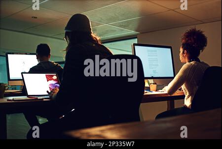 Computer, coworking team or night people programming ERP software, cybersecurity system or online server code. Startup data center, ai developer or Stock Photo