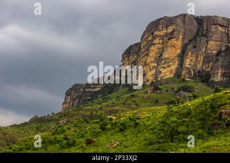 Tall sandstone cliffs, against ominous dark clouds in Royal Natal National Park, in the Drakensberg mountains of South Africa Stock Photo