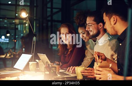 Business people, laptop and collaboration at night for team planning, project deadline or strategy at office. Group of employee designers busy working Stock Photo