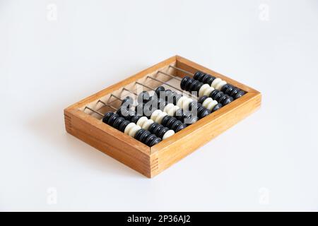 Old wooden abacus for counting money on a white background close-up Stock Photo