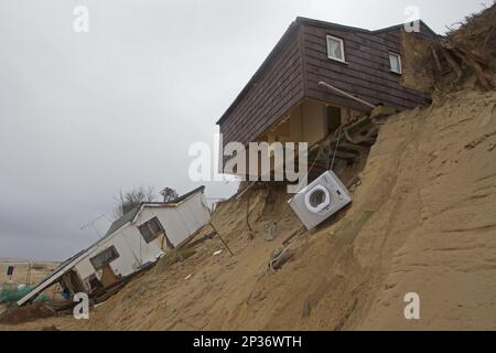 Eroded sea cliffs and damaged chalets after the December 2013 tsunami, Hemsby, Norfolk, England, United Kingdom Stock Photo