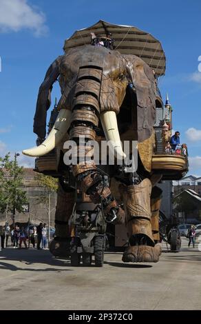 Tourists riding on gigantic mechanical elephant, The Great Elephant, Machines of the Isle of Nantes, Nantes, Loire-Atlantique, Pays de la Loire Stock Photo