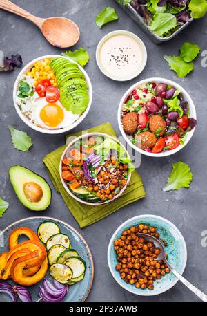 Mixed healthy vegetarian salads with vegetables, sweet potato, falafel, bulgur, avocado, eggs. Assorted buddha bowl salads. Vegetarian food. Healthy Stock Photo