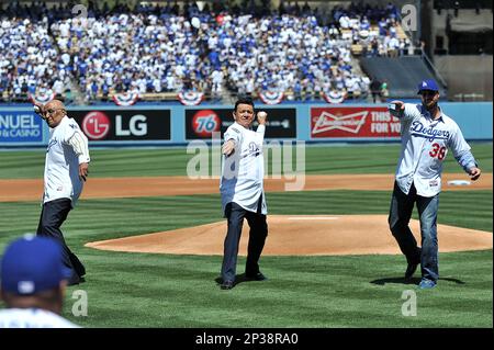 Former Dodger pitcher Fernando Valenzuela (L) throws out the first