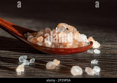 Himalayan pink salt in a wooden is used to flavor food. Due mainly to marketing costs, pink Himalayan salt is up to twenty times more expensive than t Stock Photo