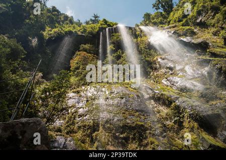 A big waterfall falling downs the rocks in Colombia from below Stock Photo