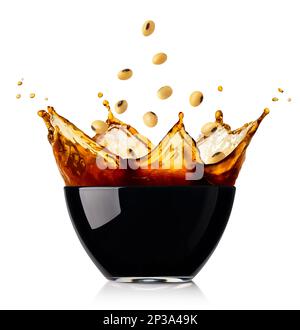 splashing soy sauce in glass bowl with falling soybeans isolated on white Stock Photo