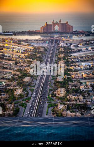 Panoramic sunset view of Palm Jumeirah with the Atlantis Hotel in the distance, shot from the edge of Aura Skypool - an infinite pool 50 floors Stock Photo