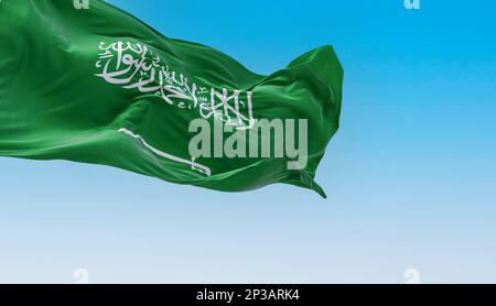 Saudi Arabia national flag waving in the wind on a clear day. Green field with Shahada and sword in Thuluth script. Rippled fabric. 3d illustration re Stock Photo