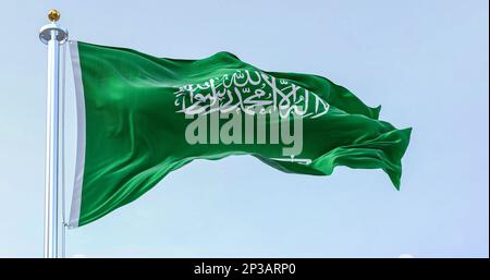 Saudi Arabia national flag waving in the wind on a clear day. Green field with Shahada and sword in Thuluth script. Rippled fabric. 3d illustration re Stock Photo