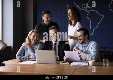 Cheerful millennial business team working on project together Stock Photo
