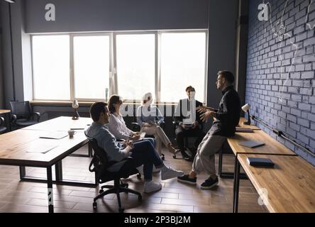 Focused millennial business group and team leader meeting in office Stock Photo