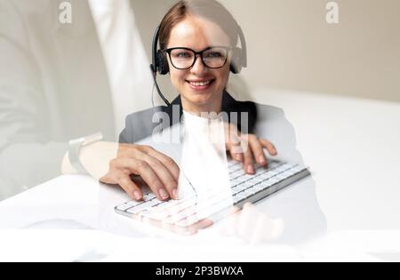 Woman customer service representative with headset smiling. Stock Photo