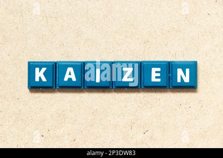 Tile alphabet letter in word kaizen on wood background Stock Photo