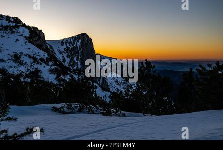 The sun sets on another snow filled day on the top of the Feuerkogul mountains in Austrian Salzkammergut Stock Photo