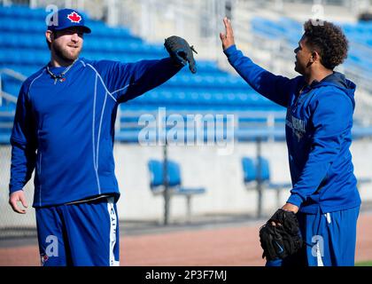 Toronto Blue Jays pitchers Marcus Stroman, right, and Pat Venditte trade  gloves in the first official workout of spring training in Dunedin, Fla.,  on Monday February 22, 2016. Venditte, who is ambidextrous