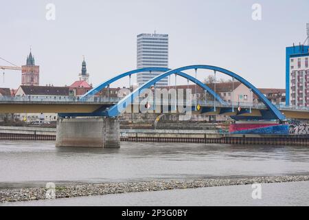 18 January 2023, Brandenburg, Frankfurt (Oder): The blue arches of the city bridge crossing the Oder River can be seen against the backdrop of the Oder Tower, St. Mary's Church, and the residential and commercial buildings standing on the riverbank. Photo: Soeren Stache/dpa Stock Photo