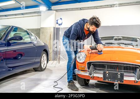 detailing of car body, polishing with using a mechanical sander, care about the car, automotive Stock Photo
