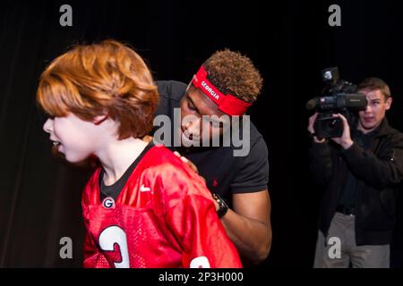 Lakeside High School s Rashad Roundtree autographs the jersey of 9