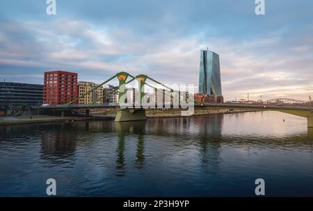 Main River skyline with Flosserbrucke Bridge and ECB Tower (European Central Bank) - Frankfurt, Germany Stock Photo