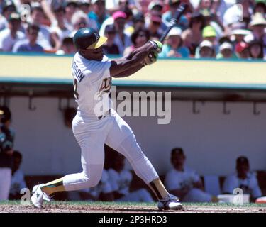 Oakland Athletics Rickey Henderson (24) goes sliding into home