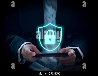 Smartphone security data technology, mobile phone device with protection shield and padlock. Large virtual digital safety shield and binary code on ce Stock Photo