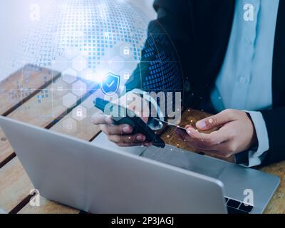 Secure payment concept. Security shield icon and lock symbol hologram appear while business people use mobile smart phone purchase with credit card in Stock Photo