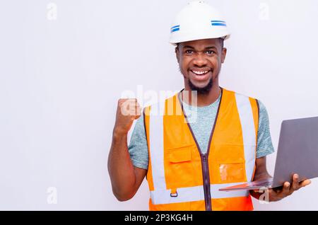 Cheerful Builder Holding Digital Tablet Smiling Looking Aside Posing On White Studio Background. Free Space, Panorama Stock Photo