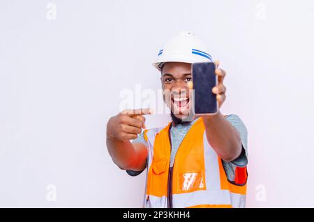 Architects holding a smartphone with isolated blank screen. Stock Photo