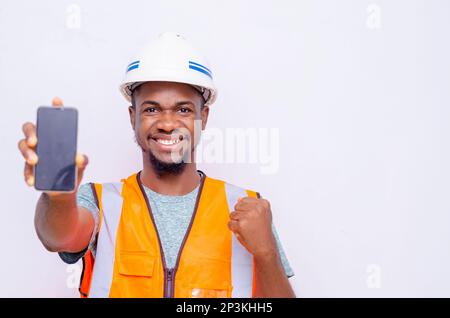 Architects holding a smartphone with isolated blank screen. Stock Photo