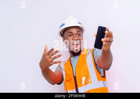 Architects holding a smartphone with isolated blank screen. Stock Photo